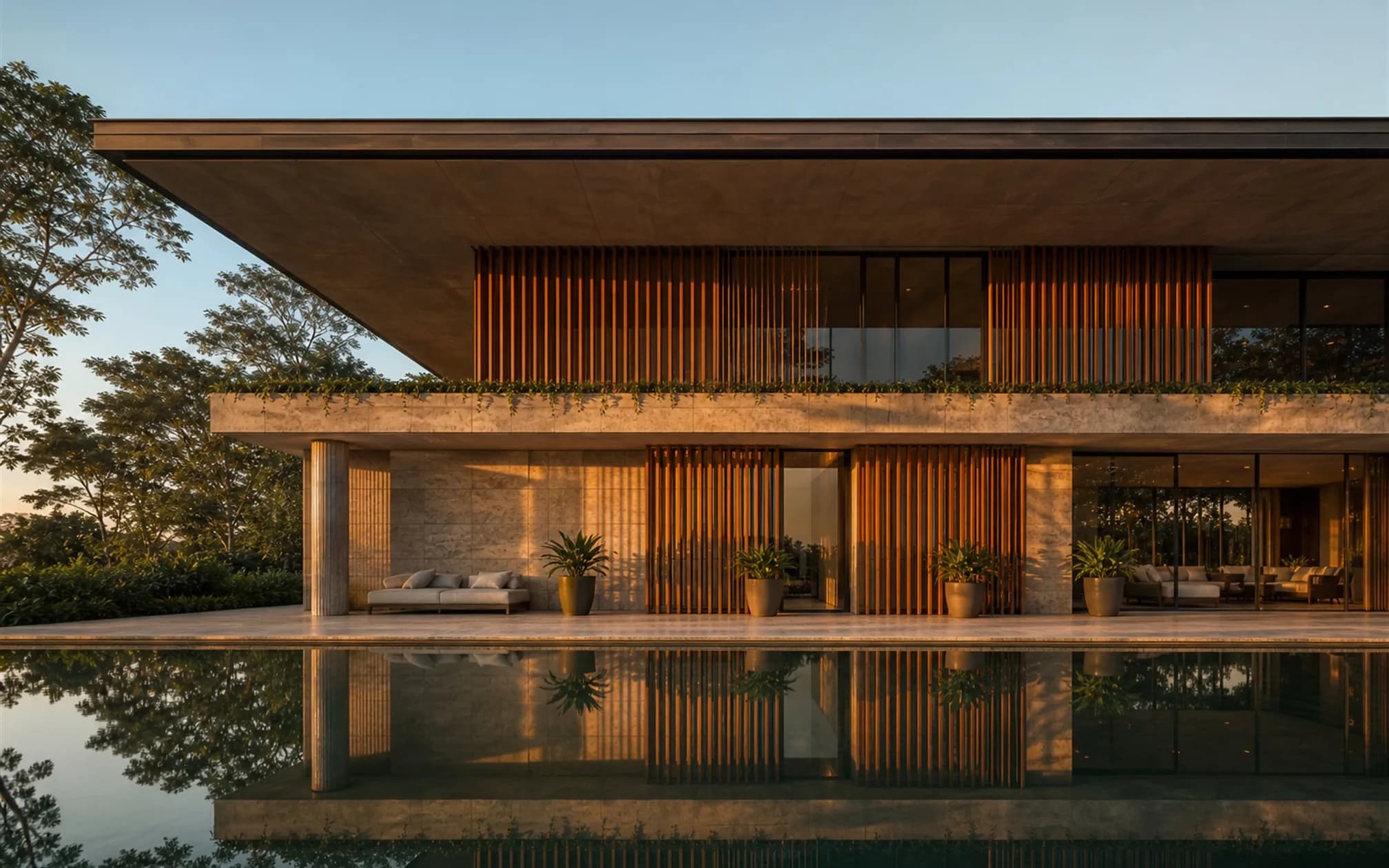 West elevation with a two-metre concrete overhang and full-height teak baffles slicing the low orange sun