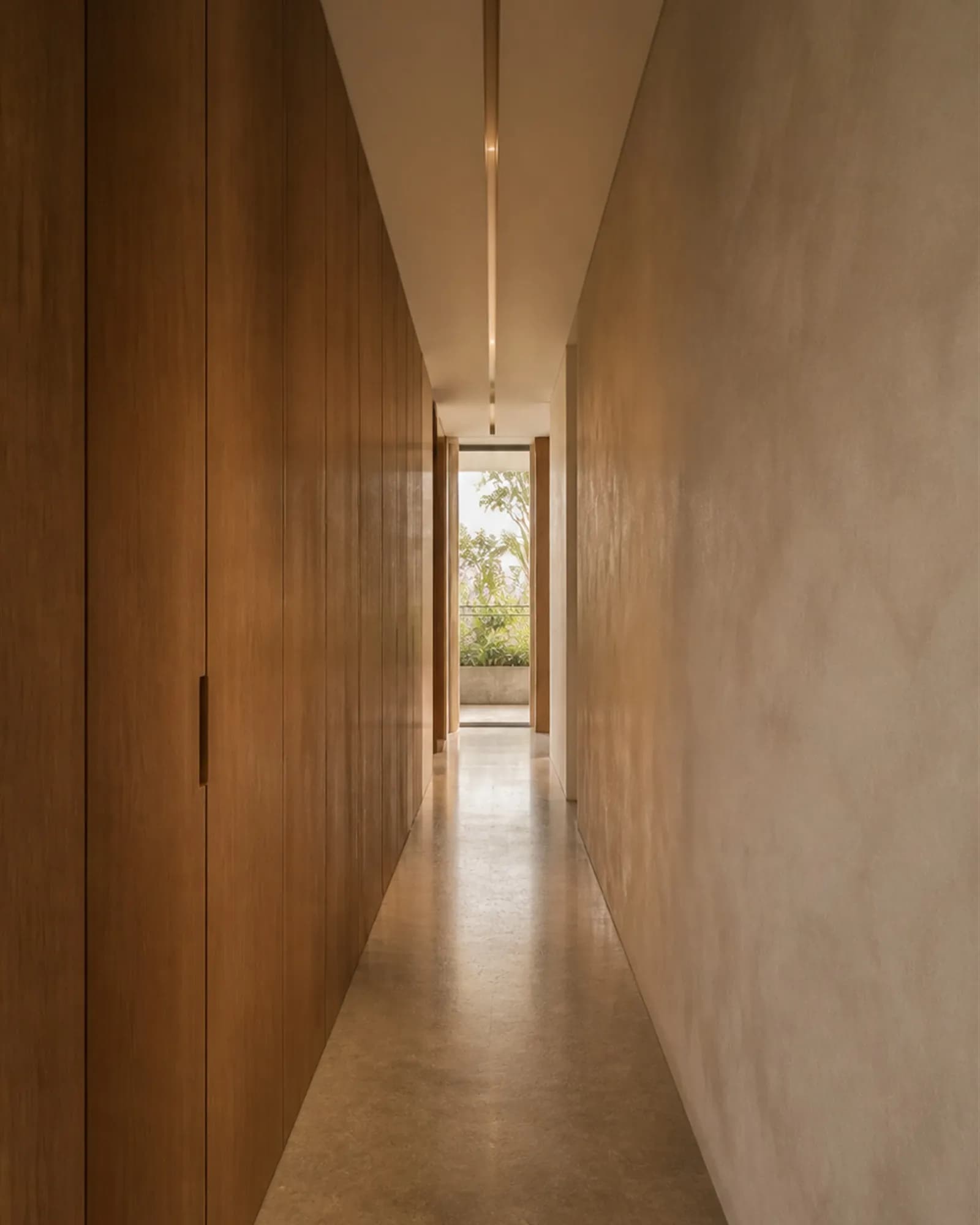 A corridor transformed from leftover space into designed architecture with a continuous recessed light channel