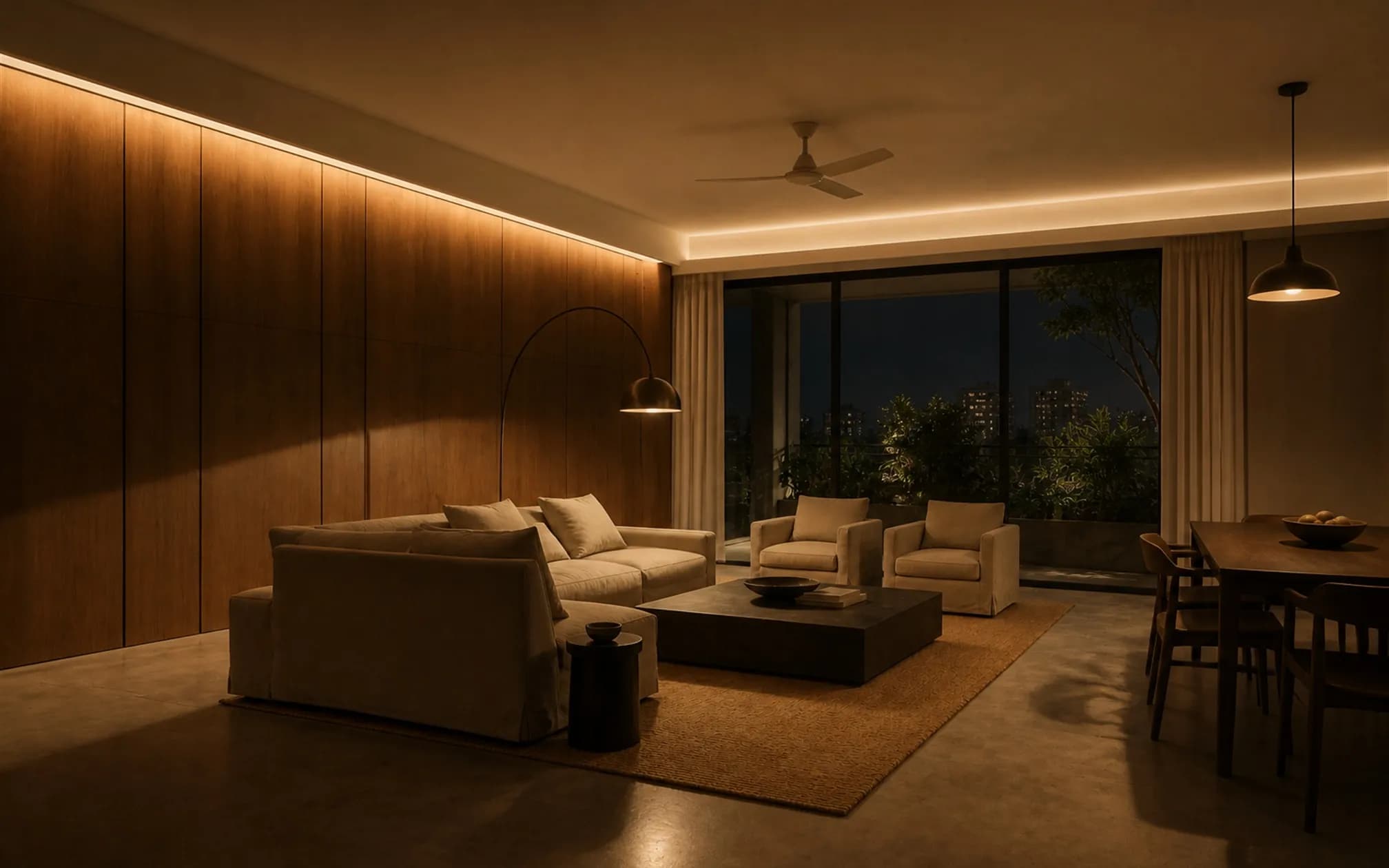 The living room at night showing layered concealed lighting with no visible downlight grid